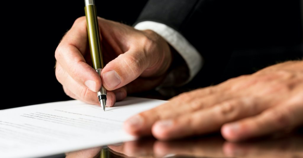 lawyer signing papers