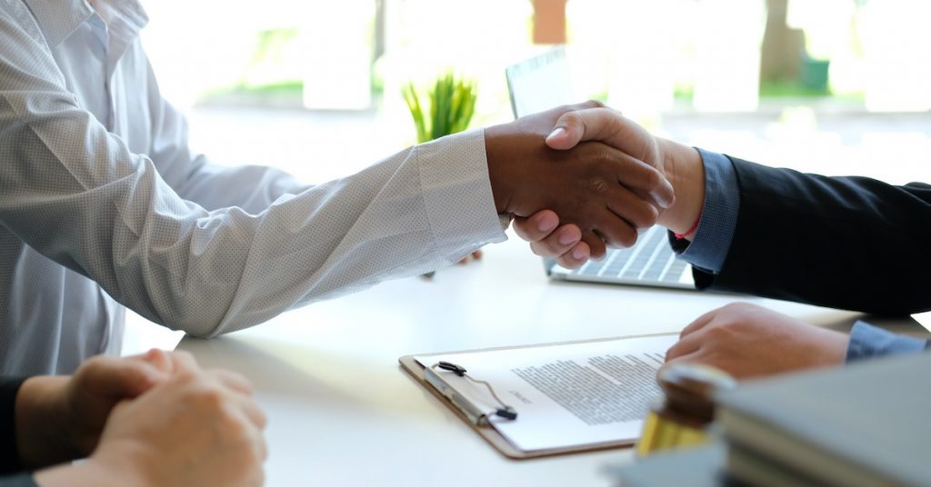 lawyer shaking hands with a client