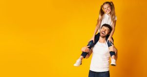 father with daughter on shoulders