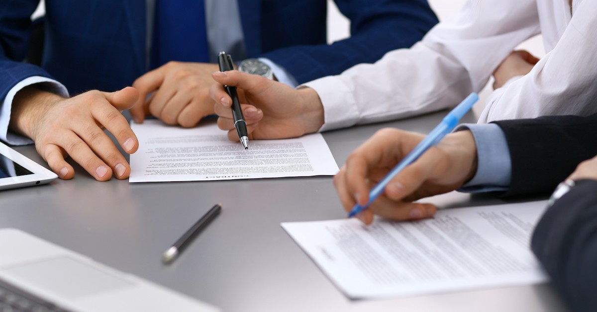 banner lawyer and clients signing papers