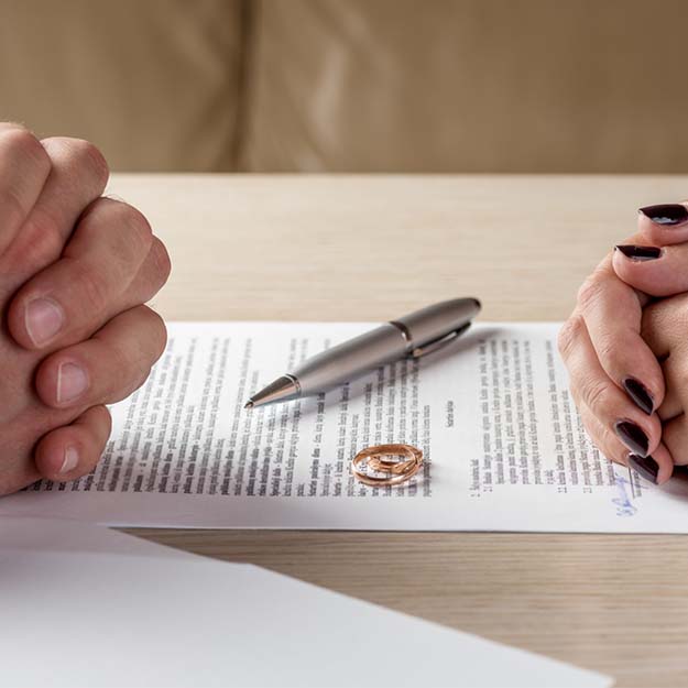 Image of a divorced couple doing paperwork_