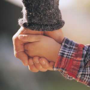Closeup of parent and child holding hands