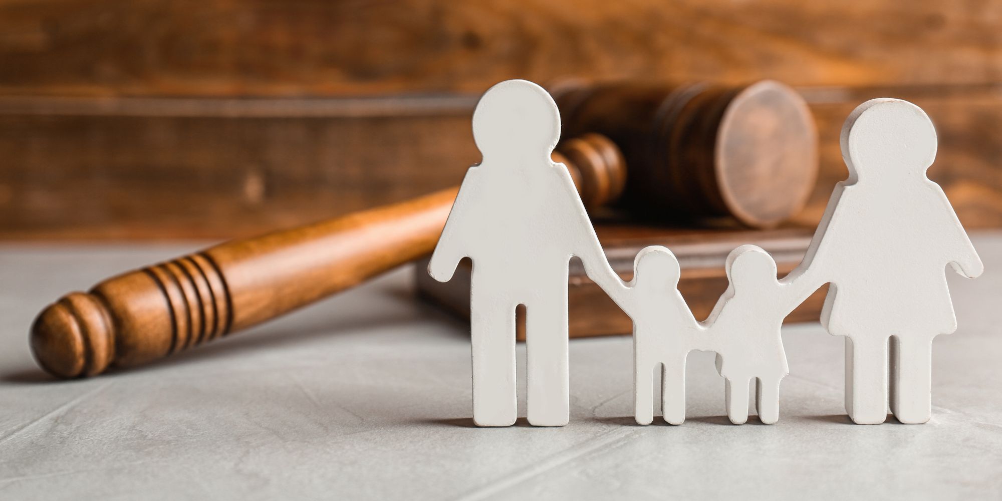 family statues next to lawyer gavel