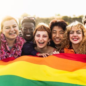 a group of people holding a rainbow flag