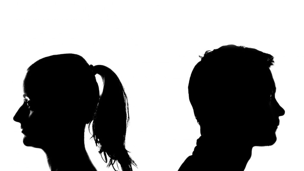 silhouette of couple facing away from each other