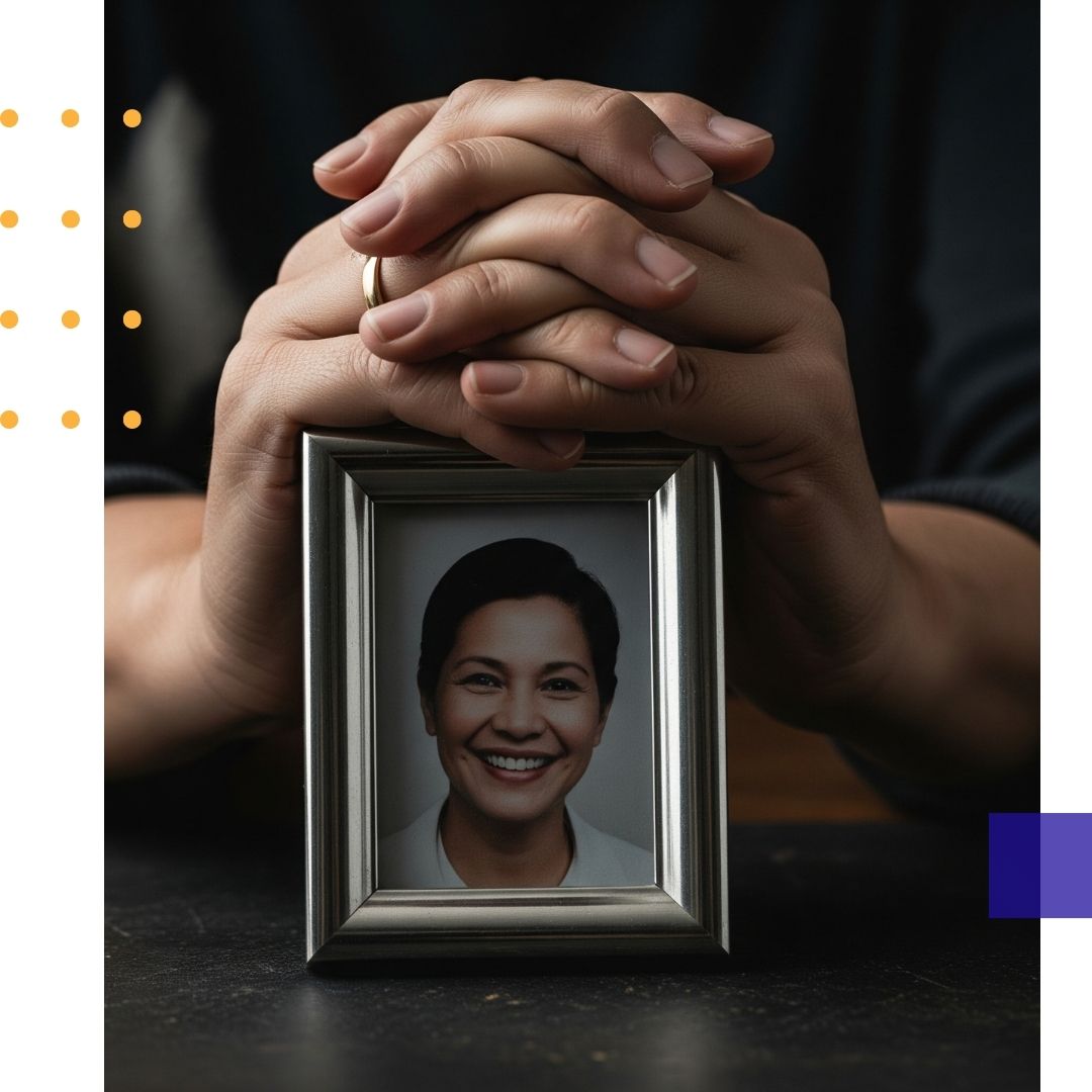 A pair of hands gently holding a framed photograph of a deceased loved one.