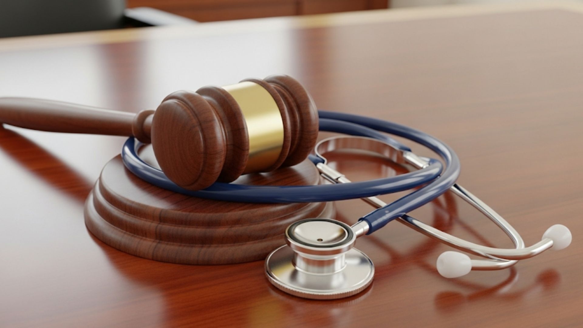 Gavel and stethoscope on a desk, symbolizing legal help for workplace injuries.