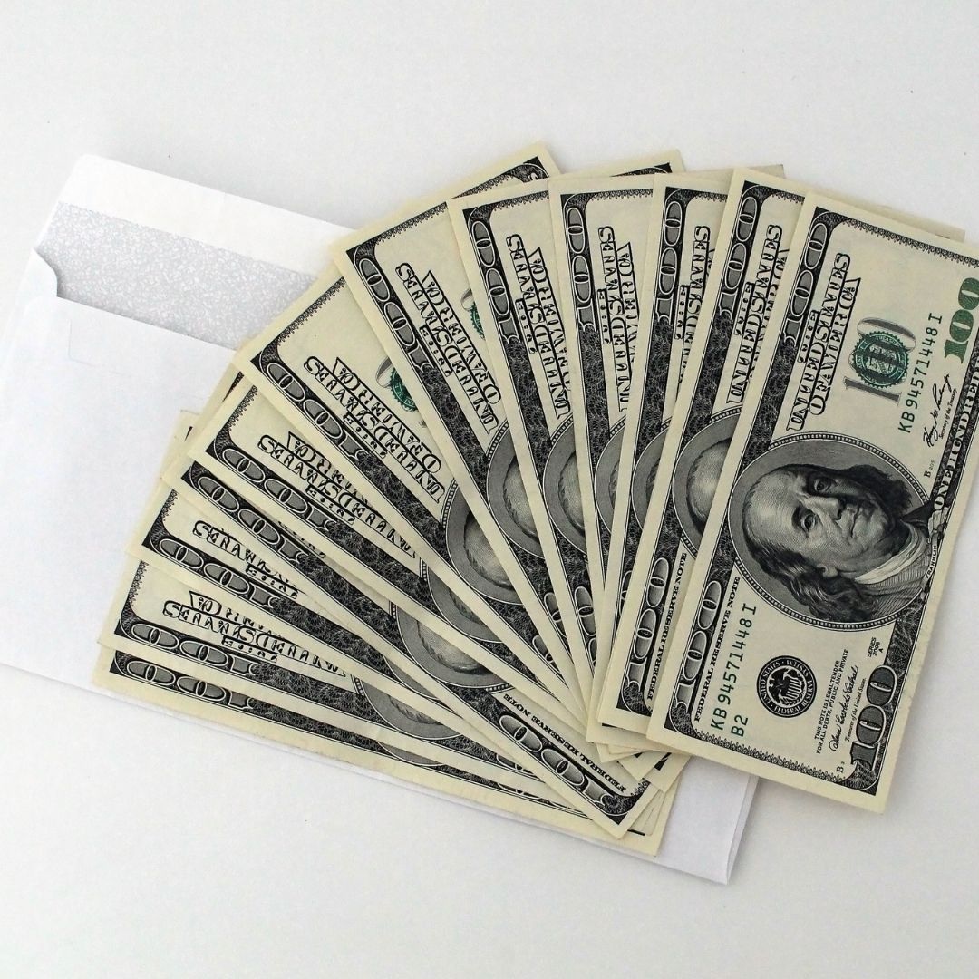 cash laid out on an envelope