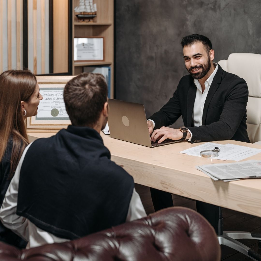 two clients meet with an attorney