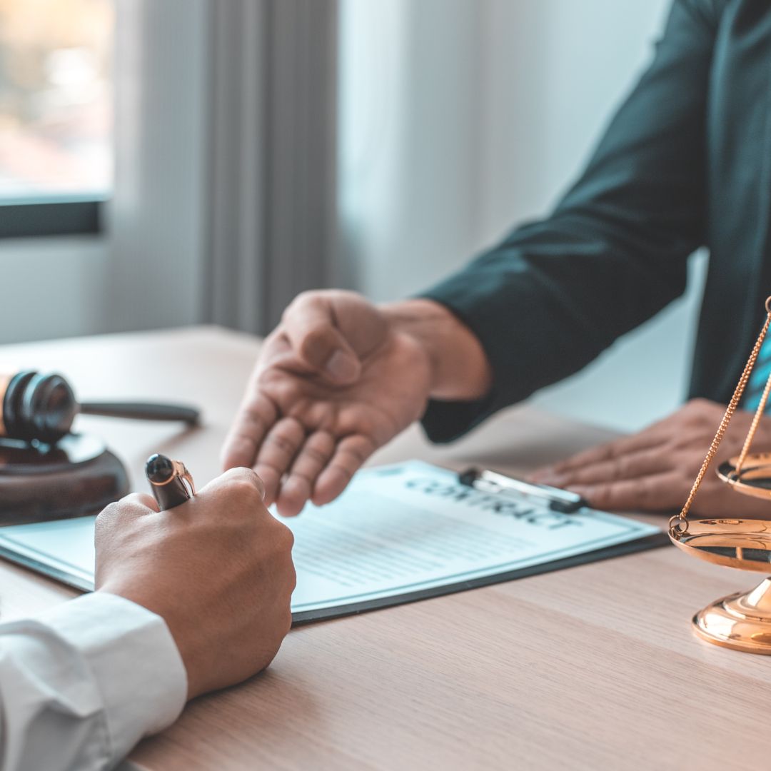 attorney working with a client on paperwork