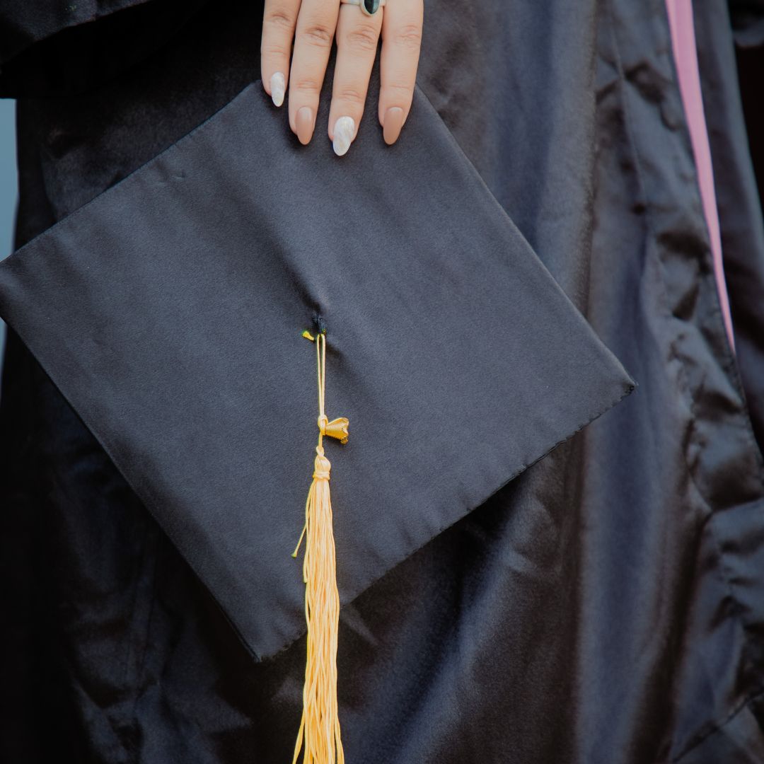 girl holding a graduation cap